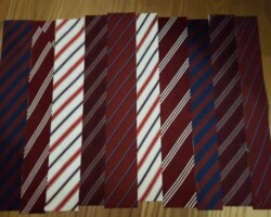 Strisce di cravatta disposte in verticale appogiate secondo la scelta personale di colori e di forme.
